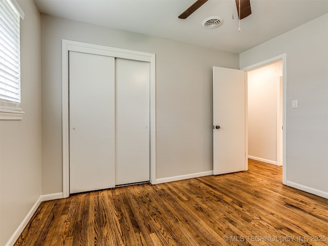 4512 SE Frank Phillips Blvd, Bartlesville, OK 74006 - unfurnished bedroom with wood finished floors, a closet, and ceiling fan