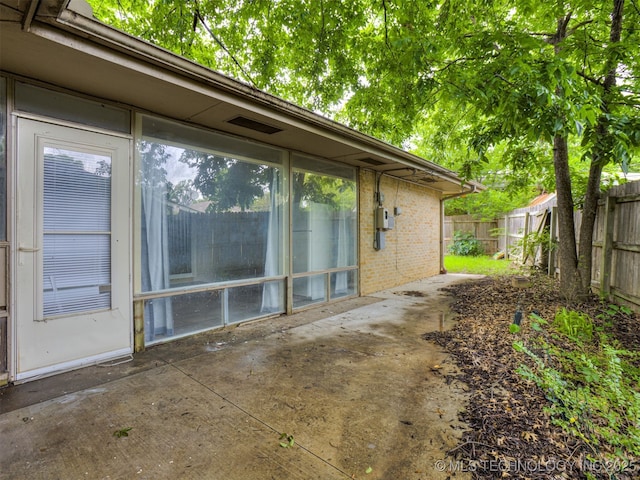 4512 SE Frank Phillips Blvd, Bartlesville, OK 74006 - view of home's exterior with a fenced backyard, a patio area, and brick siding