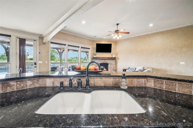 18820 S Kiowa Rd, Claremore, OK 74017 - kitchen with crown molding, a stone fireplace, open floor plan, recessed lighting, and a ceiling fan