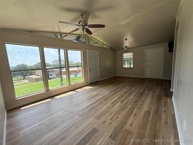 97951 S 4489th Rd, Vian, OK 74962 - unfurnished living room featuring lofted ceiling, ceiling fan, and wood finished floors