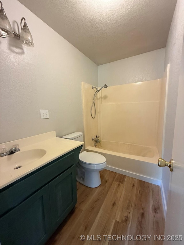 97951 S 4489th Rd, Vian, OK 74962 - bathroom with wood finished floors, a textured ceiling, vanity, bathtub / shower combination, and a textured wall
