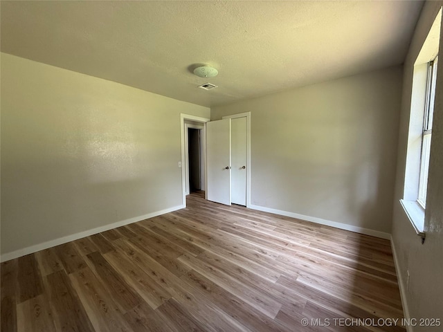 97951 S 4489th Rd, Vian, OK 74962 - spare room with wood finished floors and a textured ceiling