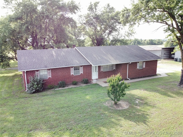 1604 N 2nd Ave, Warner, OK 74469 - single story home with brick siding, a front yard, and a shingled roof