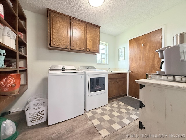 1604 N 2nd Ave, Warner, OK 74469 - laundry room with cabinet space, washer and clothes dryer, and a textured ceiling