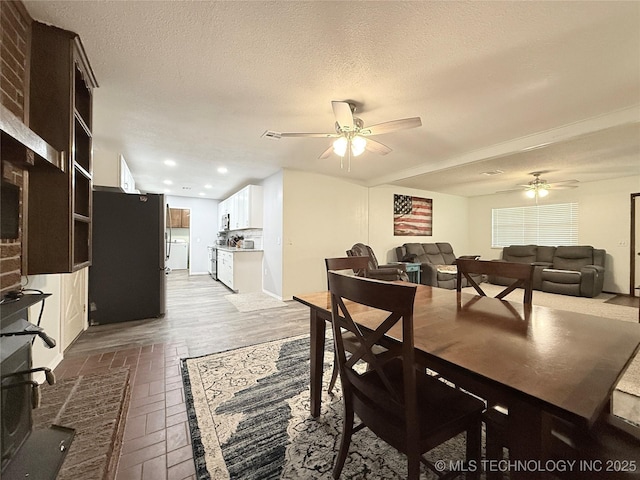 1604 N 2nd Ave, Warner, OK 74469 - dining room with ceiling fan, brick floors, recessed lighting, and a textured ceiling