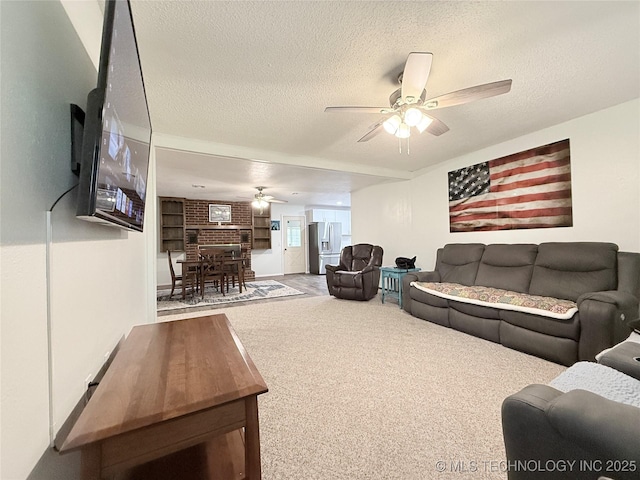 1604 N 2nd Ave, Warner, OK 74469 - carpeted living area featuring ceiling fan and a textured ceiling