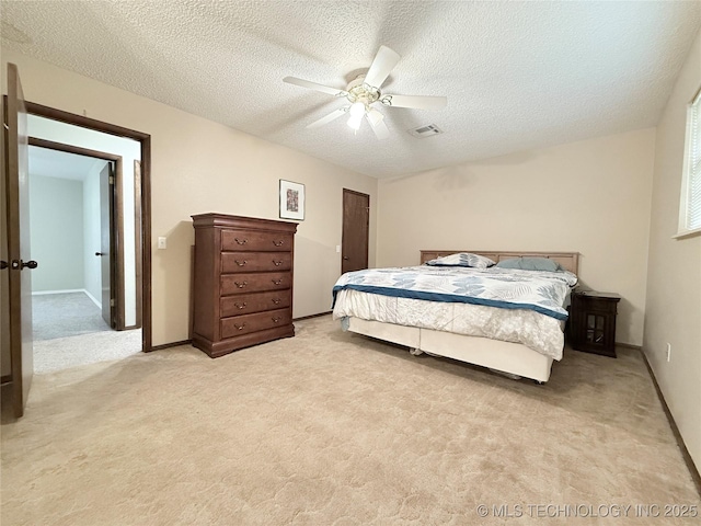 1604 N 2nd Ave, Warner, OK 74469 - bedroom featuring light carpet, a textured ceiling, and a ceiling fan