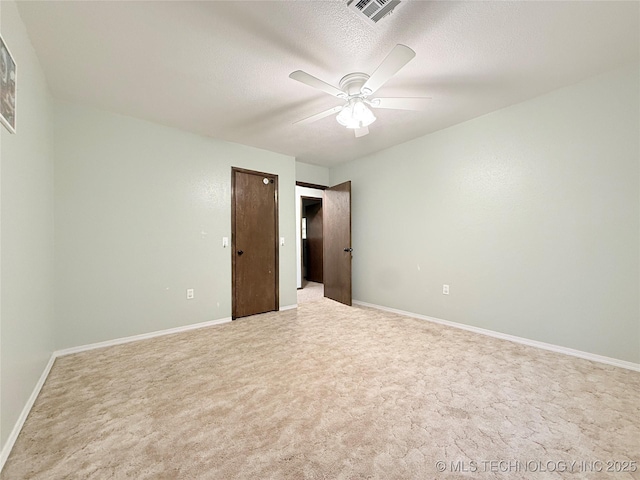 1604 N 2nd Ave, Warner, OK 74469 - unfurnished bedroom featuring light colored carpet, a textured ceiling, and ceiling fan