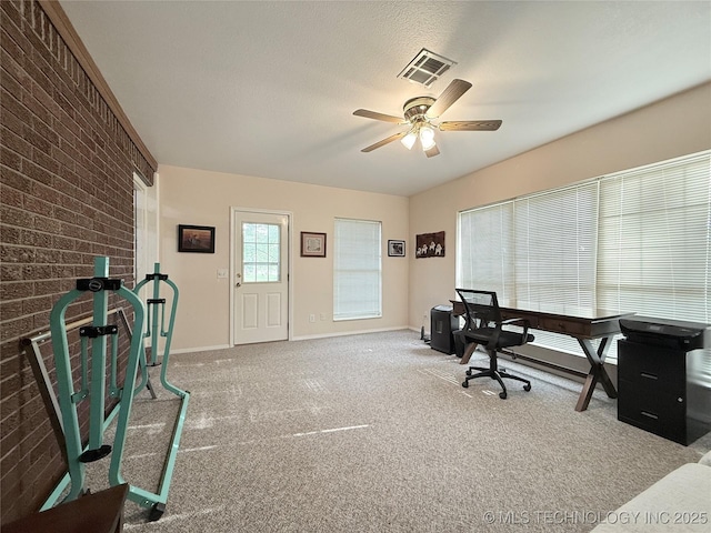 1604 N 2nd Ave, Warner, OK 74469 - home office featuring brick wall, ceiling fan, and carpet flooring