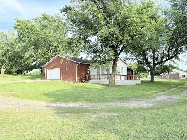 1604 N 2nd Ave, Warner, OK 74469 - view of side of home with brick siding, a garage, and a yard
