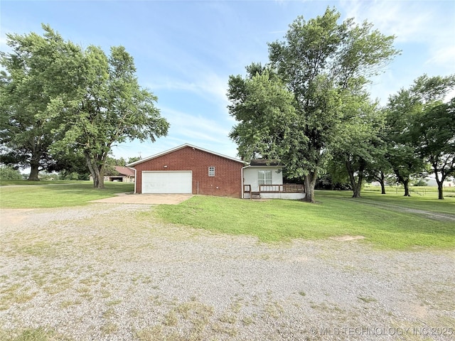 1604 N 2nd Ave, Warner, OK 74469 - view of side of property featuring brick siding, driveway, a lawn, and an attached garage