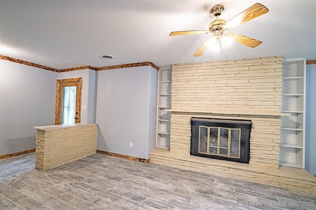 104 Laurel Pl, Bartlesville, OK 74003 - unfurnished living room featuring a ceiling fan, a fireplace, and wood finished floors