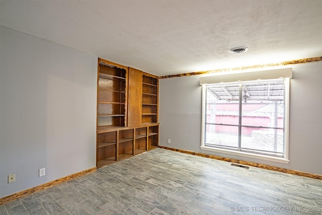 104 Laurel Pl, Bartlesville, OK 74003 - unfurnished room featuring baseboards and wood finished floors