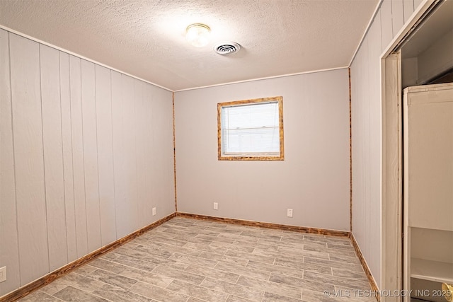 104 Laurel Pl, Bartlesville, OK 74003 - spare room with a textured ceiling and light wood-style flooring