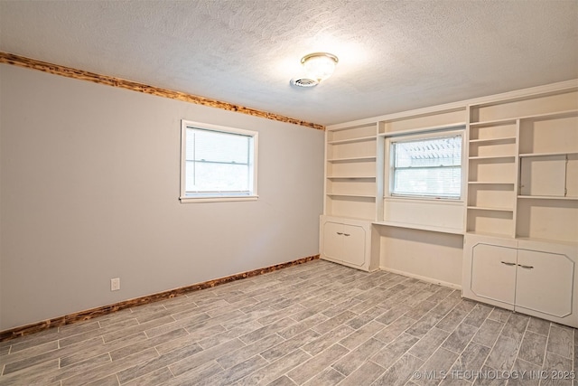 104 Laurel Pl, Bartlesville, OK 74003 - unfurnished room with a textured ceiling and light wood-type flooring