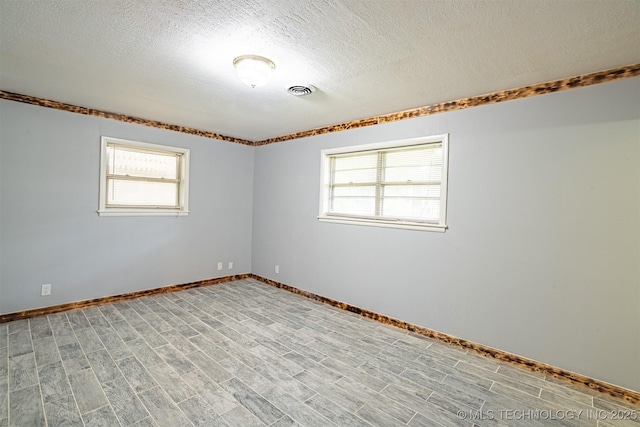 104 Laurel Pl, Bartlesville, OK 74003 - empty room with a textured ceiling and light wood-style flooring