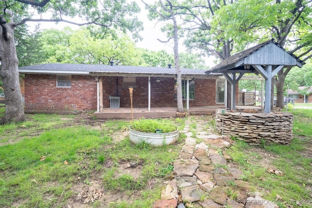 104 Laurel Pl, Bartlesville, OK 74003 - rear view of house with brick siding and a patio