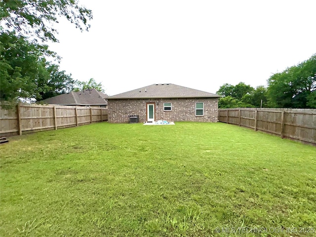2125 N Lansing Ave W, Tulsa, OK 74106 - rear view of house with a fenced backyard and brick siding