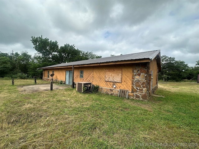 51698 W 139th St S, Drumright, OK 74030 - rear view of house with a metal roof and a lawn