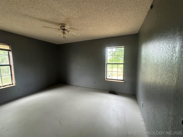 51698 W 139th St S, Drumright, OK 74030 - unfurnished room featuring ceiling fan, a textured ceiling, and concrete floors