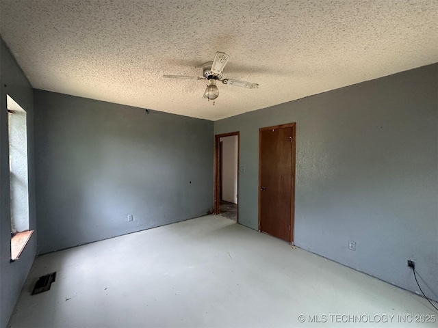 51698 W 139th St S, Drumright, OK 74030 - spare room featuring ceiling fan, concrete floors, and a textured ceiling