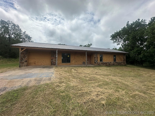 51698 W 139th St S, Drumright, OK 74030 - ranch-style home with driveway, stone siding, an attached garage, a front lawn, and a metal roof