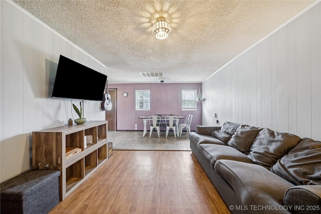 9025 N 156th Rd, Beggs, OK 74421 - living room featuring crown molding, wood finished floors, and a textured ceiling