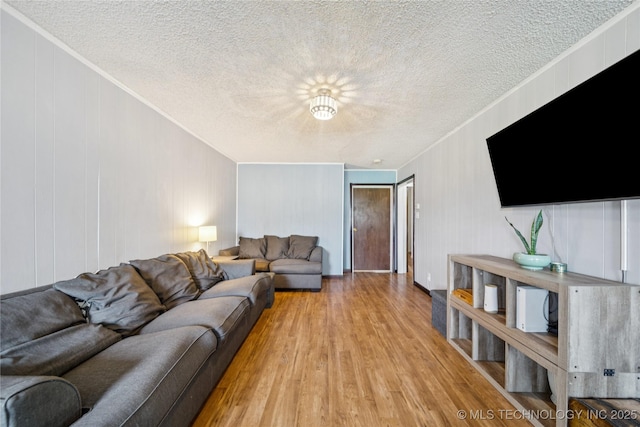 9025 N 156th Rd, Beggs, OK 74421 - living room with crown molding, a textured ceiling, and light wood finished floors