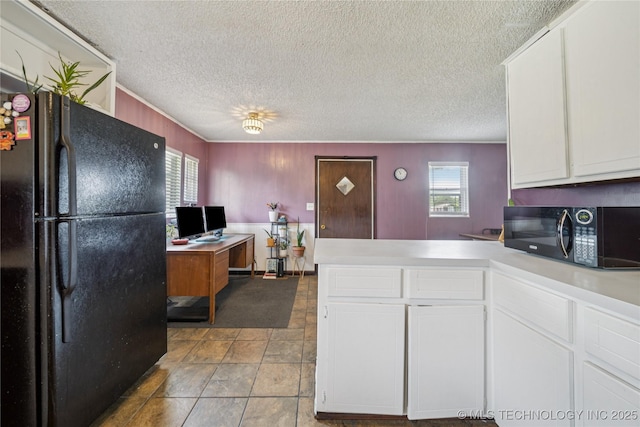 9025 N 156th Rd, Beggs, OK 74421 - kitchen featuring black appliances, healthy amount of natural light, a peninsula, white cabinets, and a textured ceiling