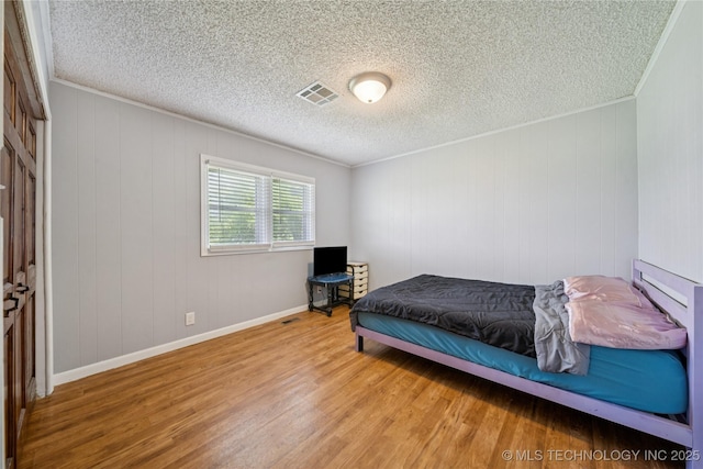 9025 N 156th Rd, Beggs, OK 74421 - bedroom featuring wood finished floors, a textured ceiling, and crown molding