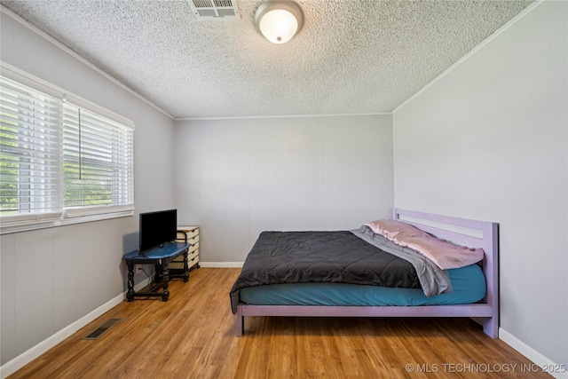 9025 N 156th Rd, Beggs, OK 74421 - bedroom with wood finished floors, a textured ceiling, and crown molding