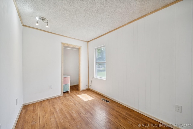 9025 N 156th Rd, Beggs, OK 74421 - unfurnished room featuring ornamental molding, a textured ceiling, and wood finished floors