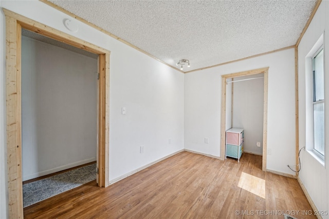 9025 N 156th Rd, Beggs, OK 74421 - unfurnished bedroom featuring a textured ceiling and light wood-style floors