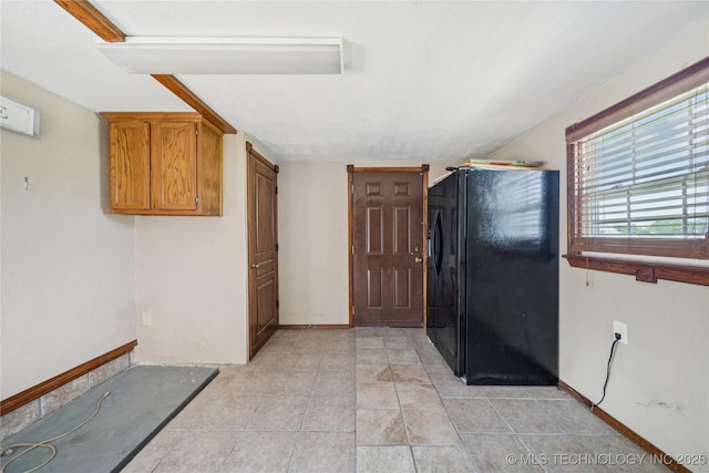 9025 N 156th Rd, Beggs, OK 74421 - kitchen featuring black refrigerator with ice dispenser, brown cabinetry, and light tile patterned floors