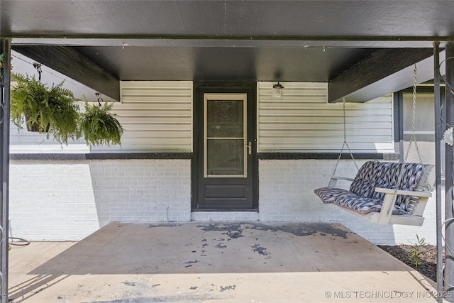 9025 N 156th Rd, Beggs, OK 74421 - view of exterior entry featuring covered porch and brick siding