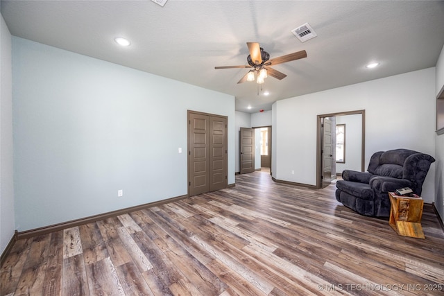 101 Dunn, Caddo, OK 74729 - unfurnished living room with a ceiling fan, wood finished floors, and recessed lighting