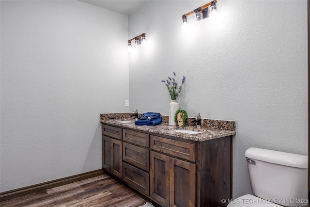 101 Dunn, Caddo, OK 74729 - bathroom featuring wood finished floors and double vanity