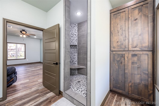 101 Dunn, Caddo, OK 74729 - bathroom with walk in shower, wood finished floors, a ceiling fan, and recessed lighting