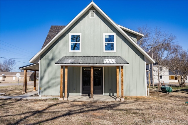 101 Dunn, Caddo, OK 74729 - rear view of house with a metal roof and board and batten siding