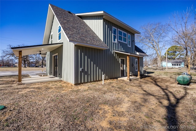 101 Dunn, Caddo, OK 74729 - back of house featuring roof with shingles, board and batten siding, and a ceiling fan