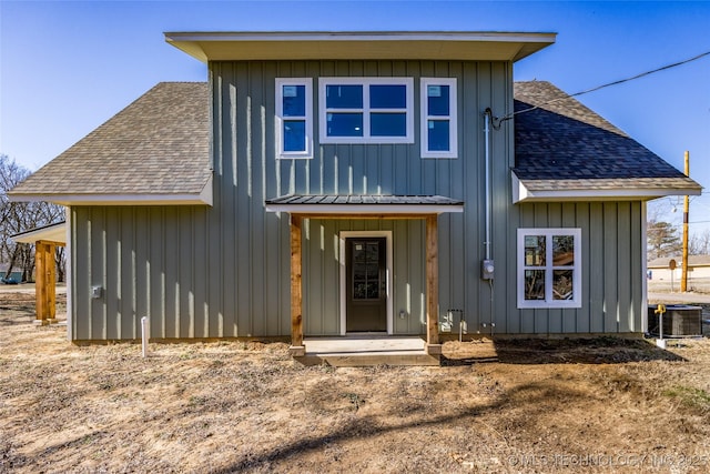 101 Dunn, Caddo, OK 74729 - back of property featuring a shingled roof and board and batten siding