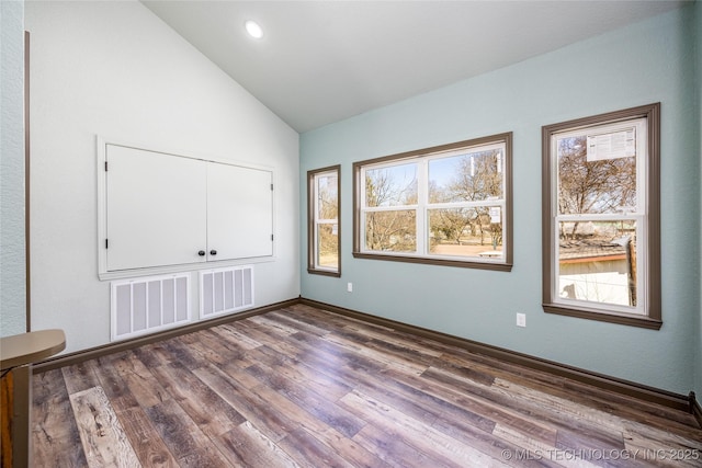 101 Dunn, Caddo, OK 74729 - unfurnished bedroom with multiple windows, lofted ceiling, wood finished floors, a closet, and recessed lighting