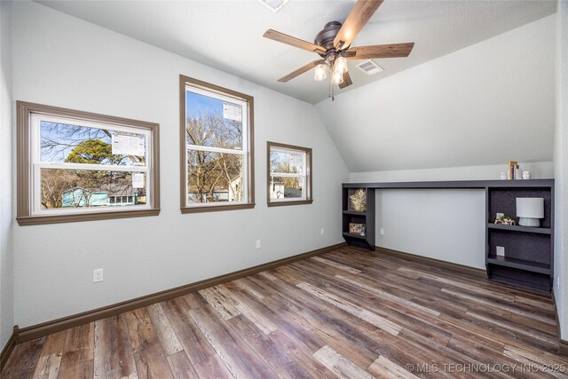 101 Dunn, Caddo, OK 74729 - additional living space featuring ceiling fan, wood finished floors, and vaulted ceiling