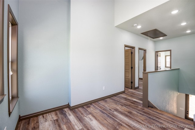 101 Dunn, Caddo, OK 74729 - unfurnished room with attic access, wood finished floors, and recessed lighting