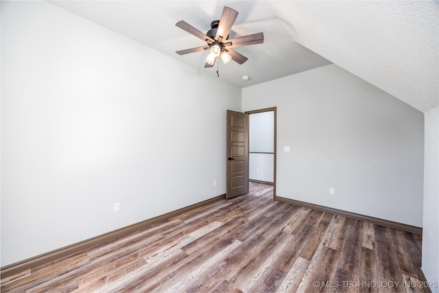 101 Dunn, Caddo, OK 74729 - unfurnished bedroom with wood finished floors, lofted ceiling, and ceiling fan