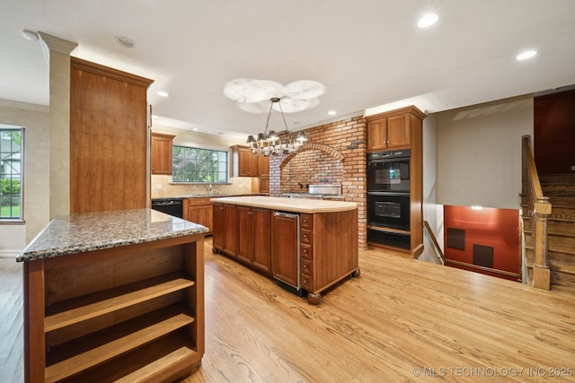 11637 W 86th St S, Sapulpa, OK 74066 - kitchen with black appliances, light wood finished floors, brown cabinetry, a kitchen island, and open shelves