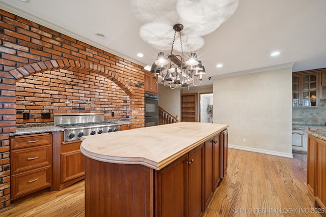 11637 W 86th St S, Sapulpa, OK 74066 - kitchen with butcher block counters, stainless steel gas stovetop, light wood-type flooring, glass insert cabinets, and a kitchen island