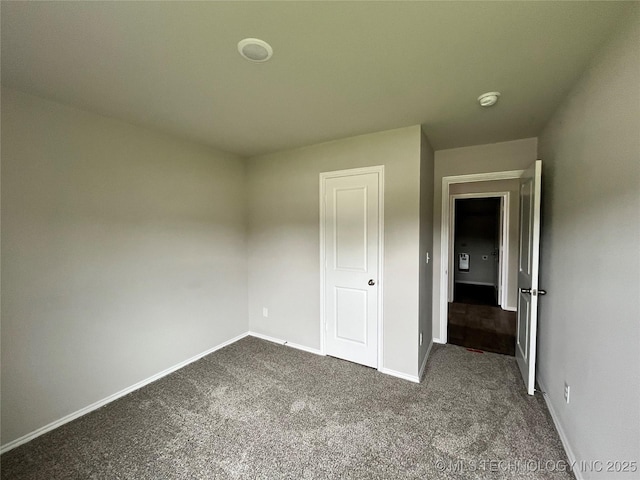 3118 SE Talimena Ct, Bartlesville, OK 74006 - unfurnished bedroom featuring dark carpet and baseboards