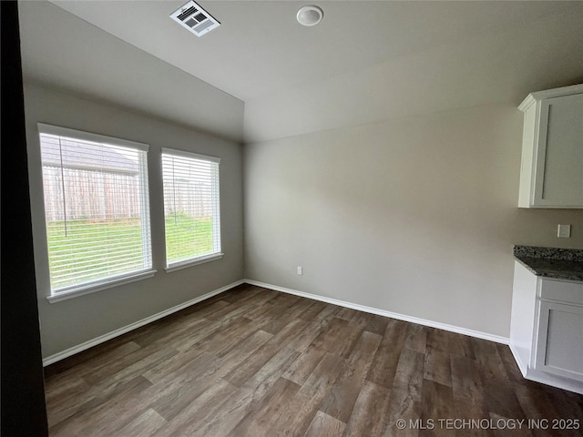3118 SE Talimena Ct, Bartlesville, OK 74006 - unfurnished dining area with vaulted ceiling and dark wood-style flooring
