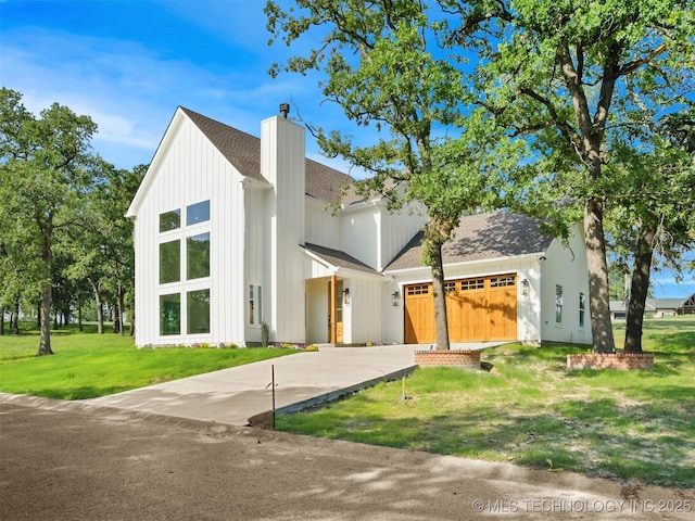 2 Valley View Dr, Burneyville, OK 73430 - modern inspired farmhouse featuring a chimney, a garage, a front yard, driveway, and roof with shingles